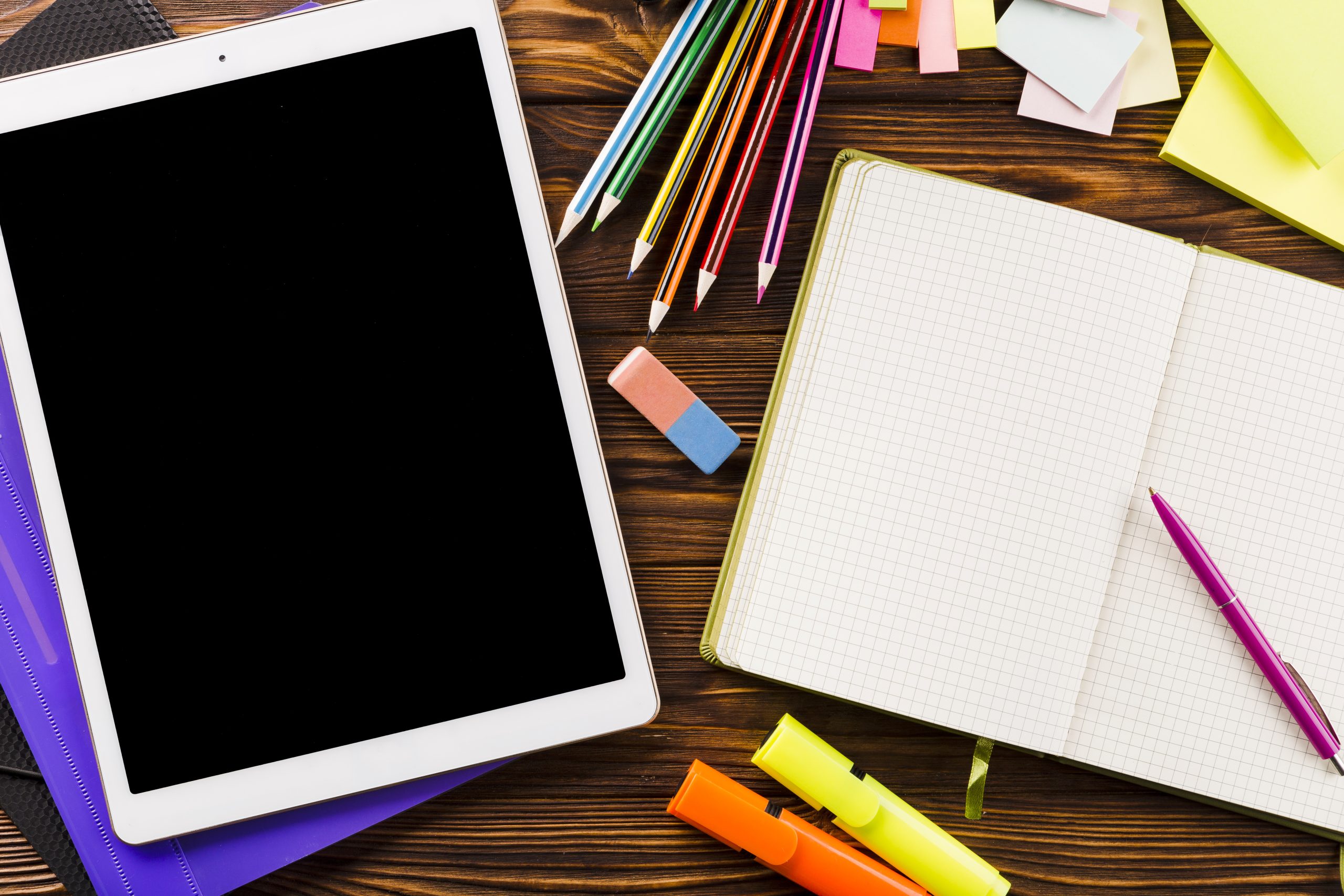 tablet-lying-near-stationery